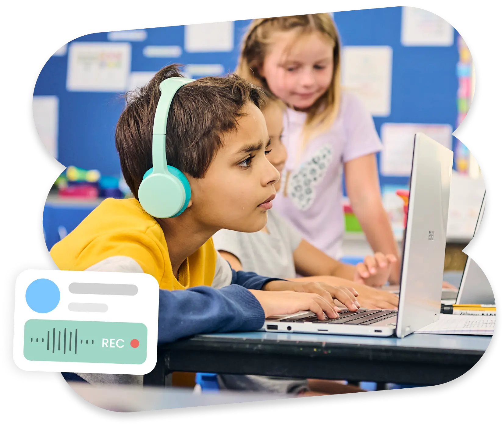 A student has headphones on and is focused on their work on the laptop